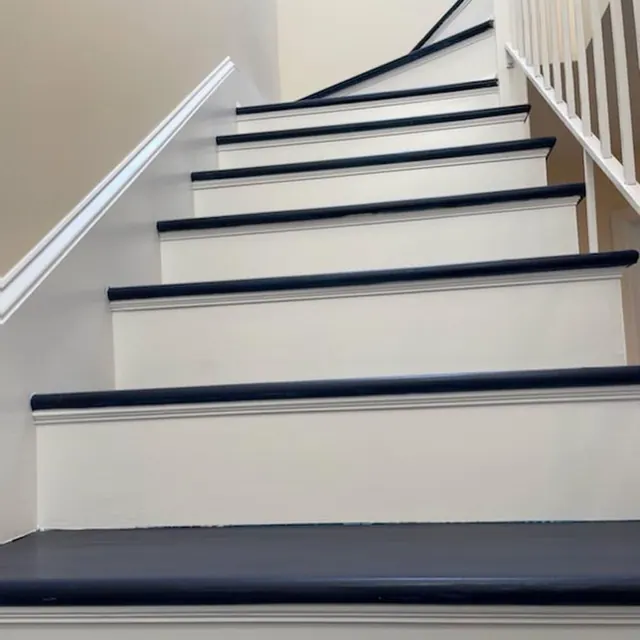 Stair treads stained navy over white risers