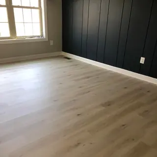 White oak floor in a room with a black shiplap accent wall