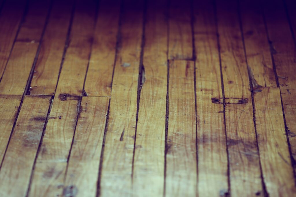 Close view of damaged hardwood floors.